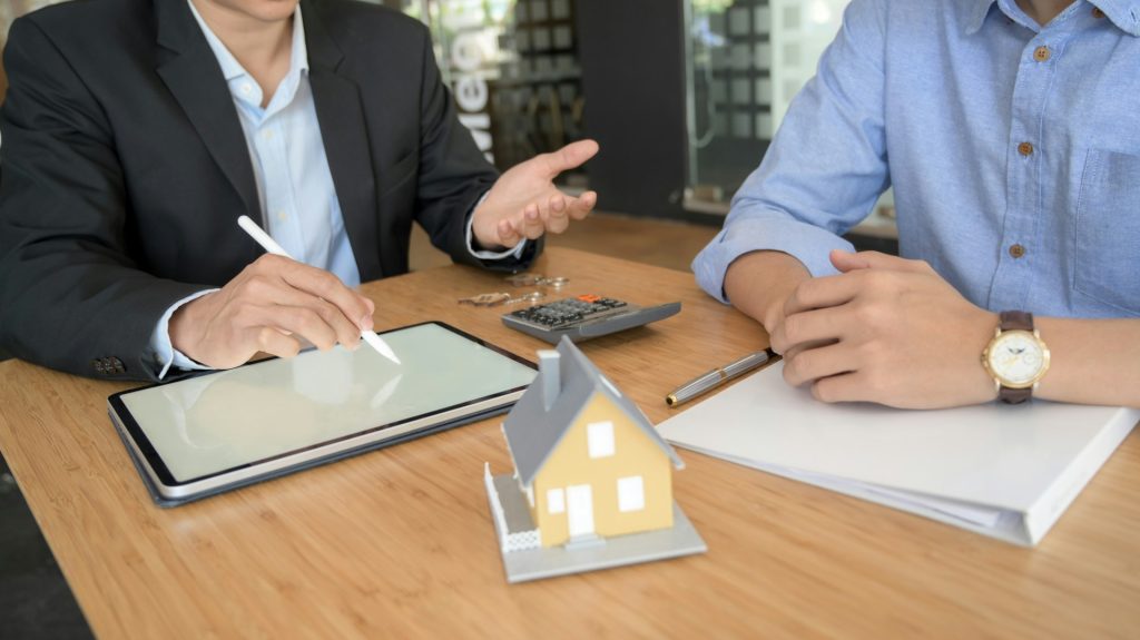 Insurance agent explaining services to a client in the office cabin
