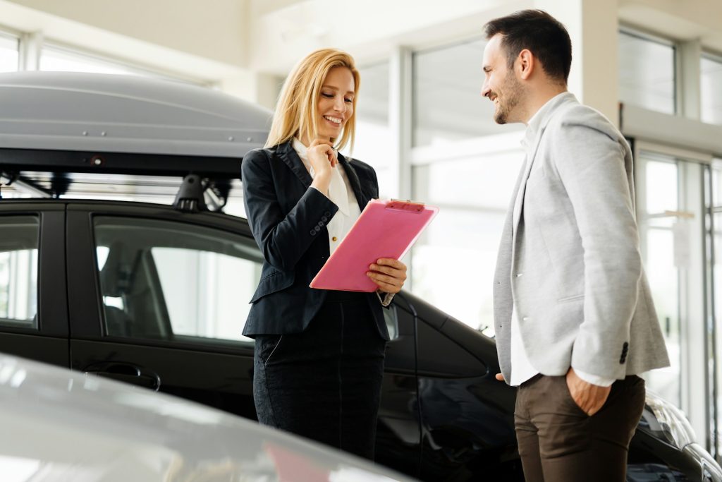 Agent explaining auto insurance coverage details to a client